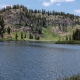 Image of a mountain landscape with a body of water in the foreground.