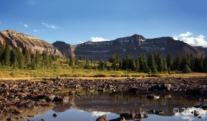 The late Precambrian-age Red Castle and Dead Horse Pass Formations, carved by Quaternary glaciers, form the cirque above Henrys Fork basin in the Uinta Mountains. A popular backpacking destination, Henrys Fork basin lies beneath the highest point in Utah, Kings Peak (13,528 feet; on the skyline in middle of photo). High Uintas Wilderness Area, Summit County. Photographer: Adam Hiscock © 2016