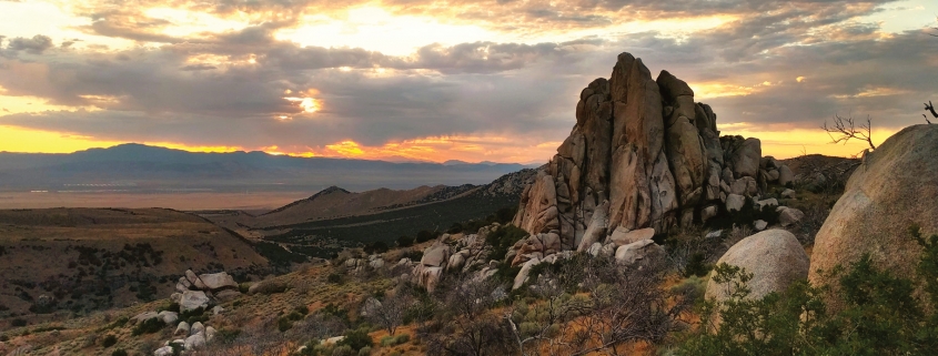 Miocene-age granite in the Mineral Mountains glows as the sun sets over the distant San Francisco Mountains near Milford.