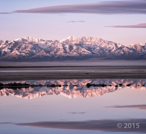 Alpenglow illuminates the glacially sculpted Stansbury Mountains as seen from the shores of Great Salt Lake. Deseret Peak (11,031 feet), the leftmost high summit, is the range’s highest peak and is underlain by Cambrian-age Prospect Mountain Quartzite. Stansbury Mountains, Tooele County, Utah. Photographer: Gregg Beukelman; © 2015