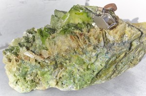 Bonanza grade gold sample from the Trixie mine, Tintic district, Utah County. Native gold and green-blue tellurium minerals (including bright green xocomecatlite, a rare copper tellurate) are forming on bladed barite and cavity-filling quartz. Tintic is one of Utah's oldest mining districts and has produced significant silver, gold, lead, zinc, and copper. Photo courtesy of Tintic Consolidated Metals.