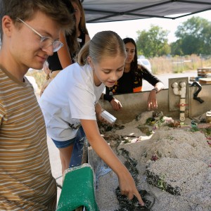 A table filled with sand simulating a stream.