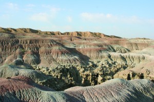 On top of the sandstone that forms Fantasy Canyon, a mudstone layer with alternating gray, olive, and reddish-purple stripes erodes into characteristic badland topography with guttered slopes.