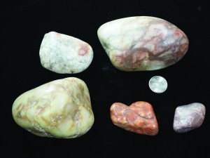 Smooth, multicolored dropstone samples just larger than a quarter.