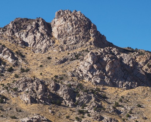 Exposed white and black rock areas on a hill.
