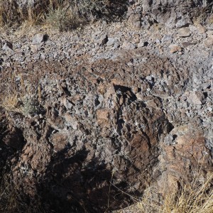 Gray, brown, and black rugged rock outcrop.