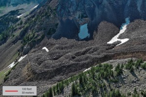 An aerial view of a rocky valley with large bump features and steep front.
