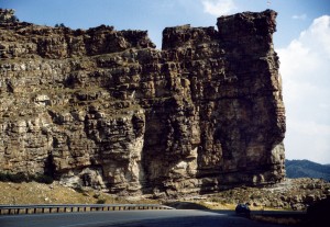 Castle Gate in Price River Canyon (view looking east) is composed of the Castlegate Sandstone of the Cretaceous Mesaverde Group. The Castlegate Sandstone was deposited in an ancient braided stream system and produces gas at Natural Buttes field in the eastern Uinta Basin. Photo courtesy of Robert Ressetar.