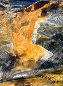 The Manefay landslide at the Bingham Canyon open-pit copper mine on April 11, 2013. Also notable are the two different slides—the earlier light gray slide of pyritized Bingham Mine Formation quartz sandstones overlain by the yellow-brown, oxidized dump material which slid about 1.5 hours later. Multiple pieces of mining equipment caught up in the slide are barely visible at the toe of the slide in the lower left. Photo courtesy of Kennecott Utah Copper.